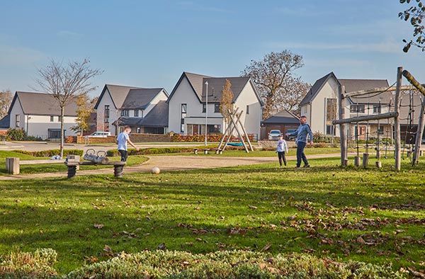 A family playing football at a Crest Nicholson development