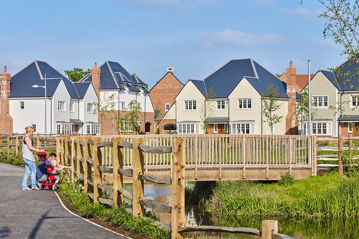 Family enjoying sights of park and lake at a Crest Nicholson development