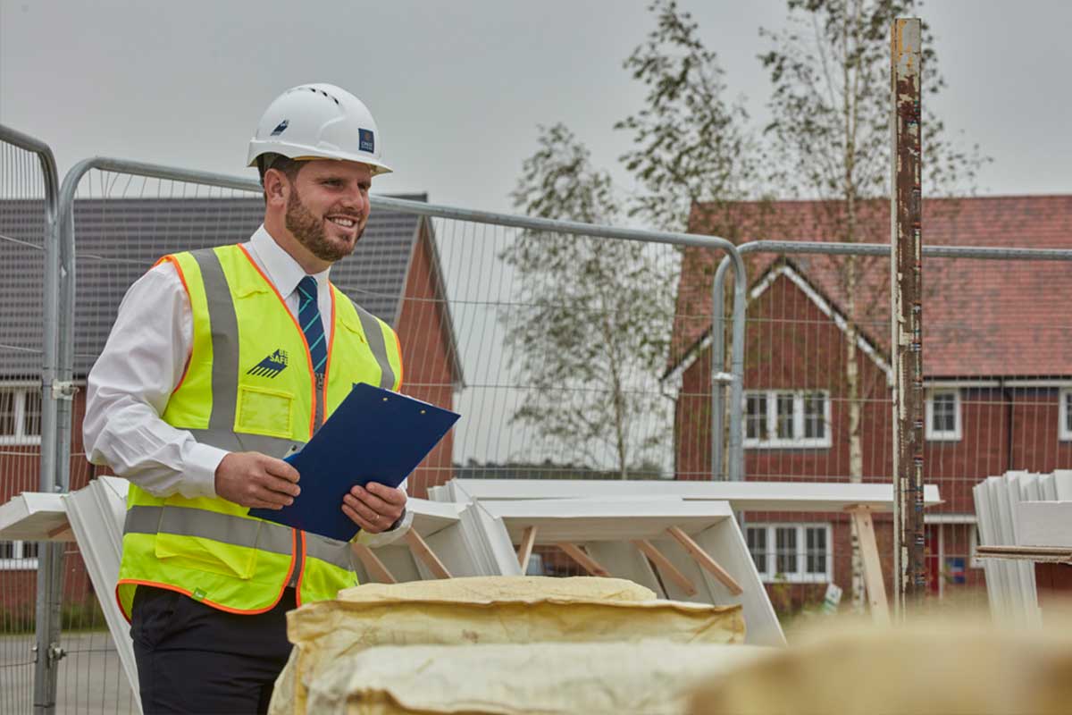 Crest Nicholson staff with hard hat and high vis