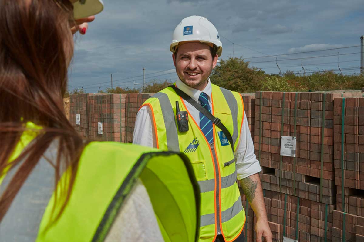 Crest Nicholson staff with hard hat and high vis