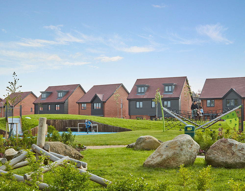 A family playing football at a Crest Nicholson development