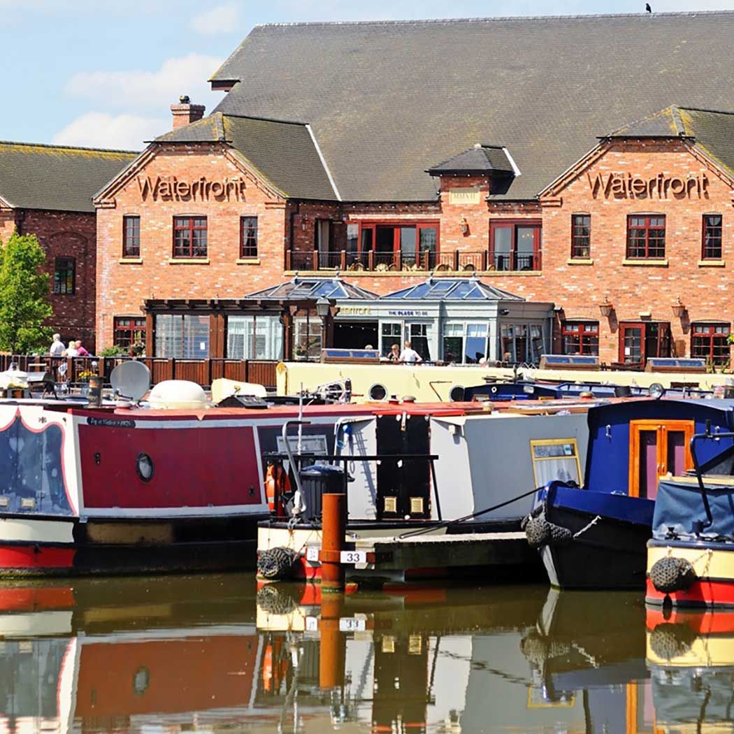 pub on the canal front with canal boats in water