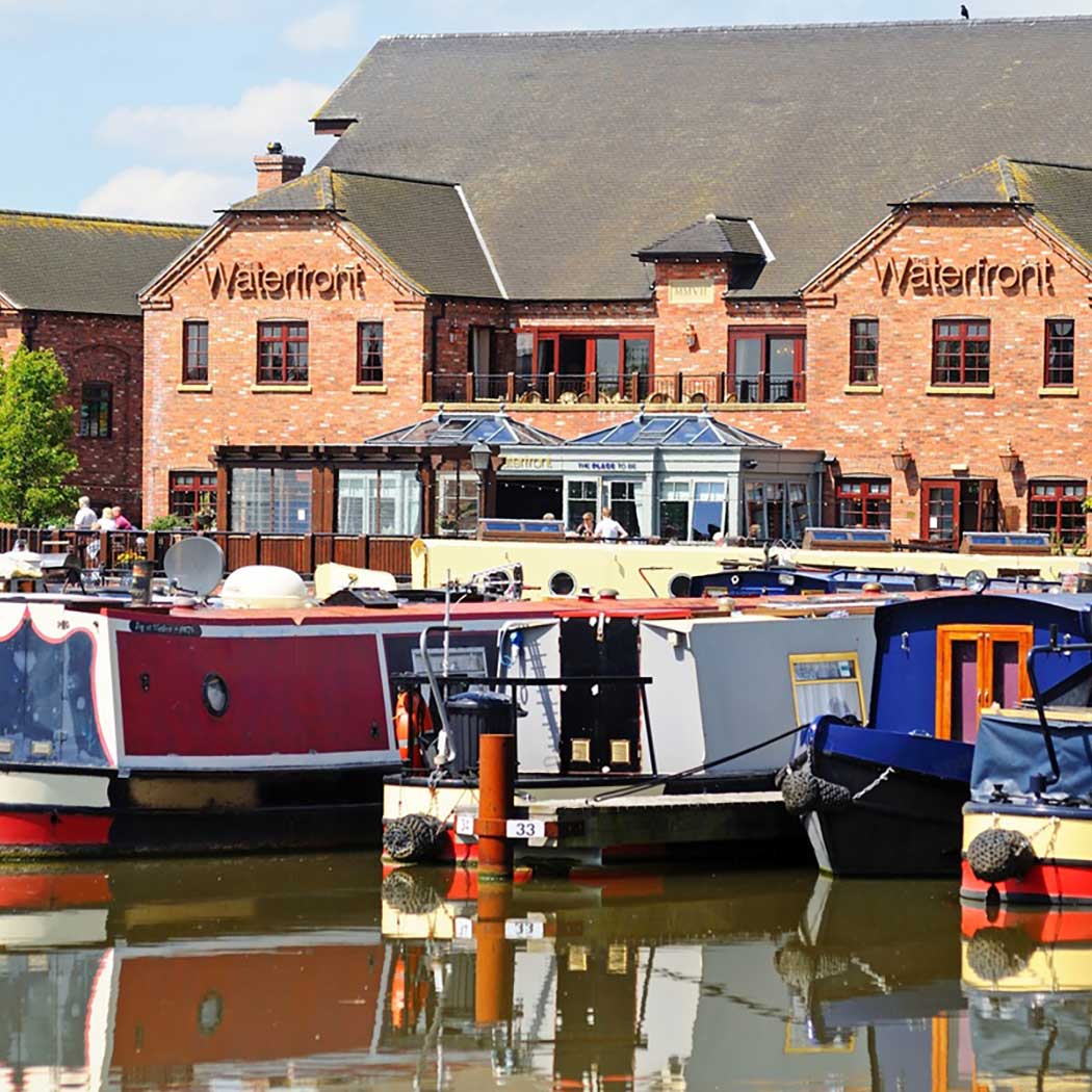 pub on the canal front with canal boats in water