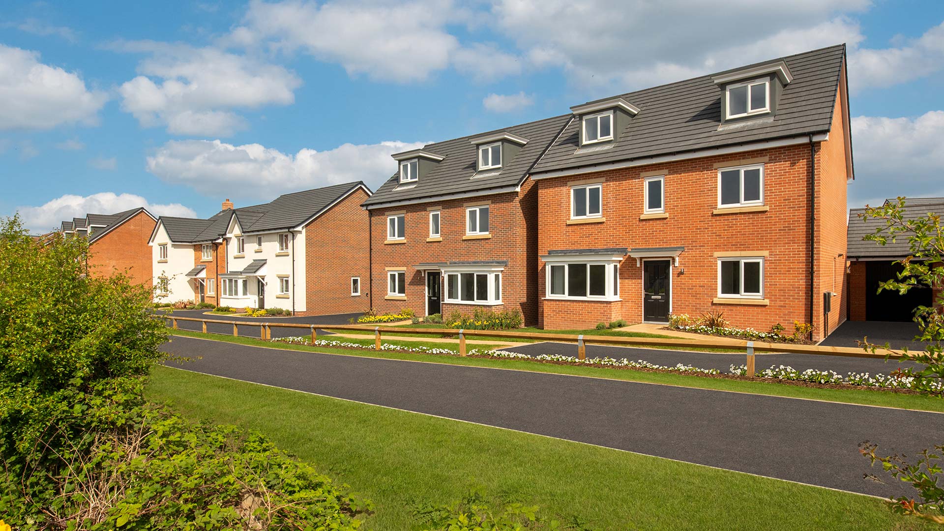 Street scene photography taken at Sketchley Gardens - featuring detached homes such as the three storey Windsor house type overlooking green open space.