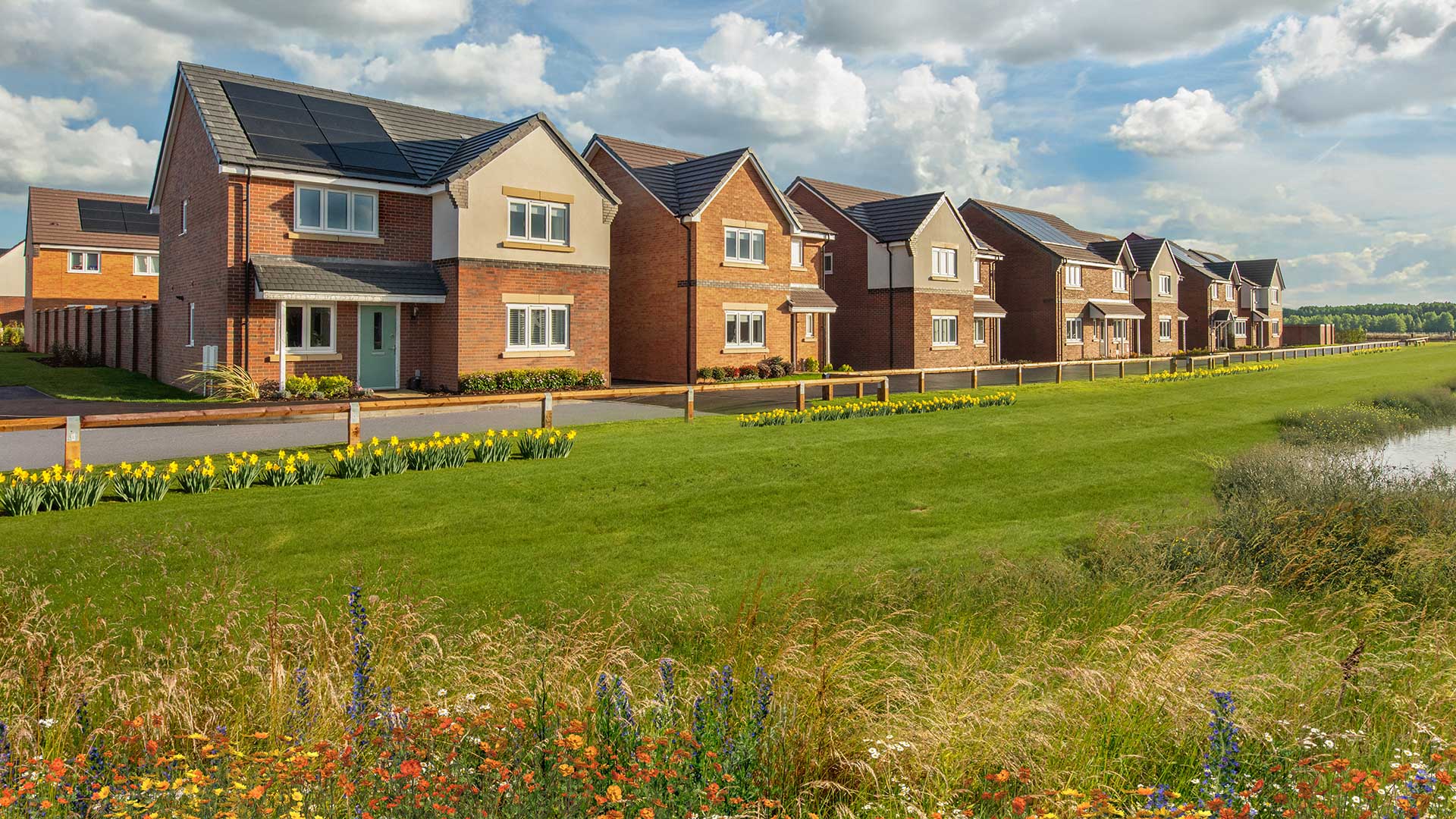 Street scene photography taken at Branston Locks - featuring detached home overlooking green open space.