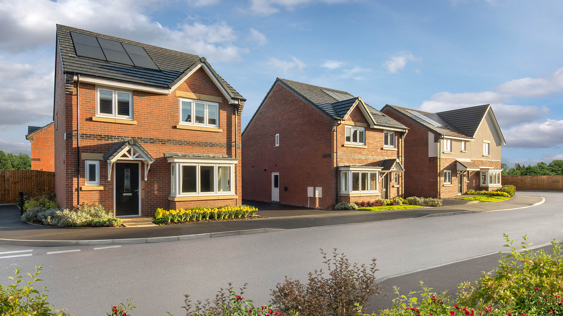 Street scene photography taken at Branston Locks - featuring brick homes overlooking green open space.