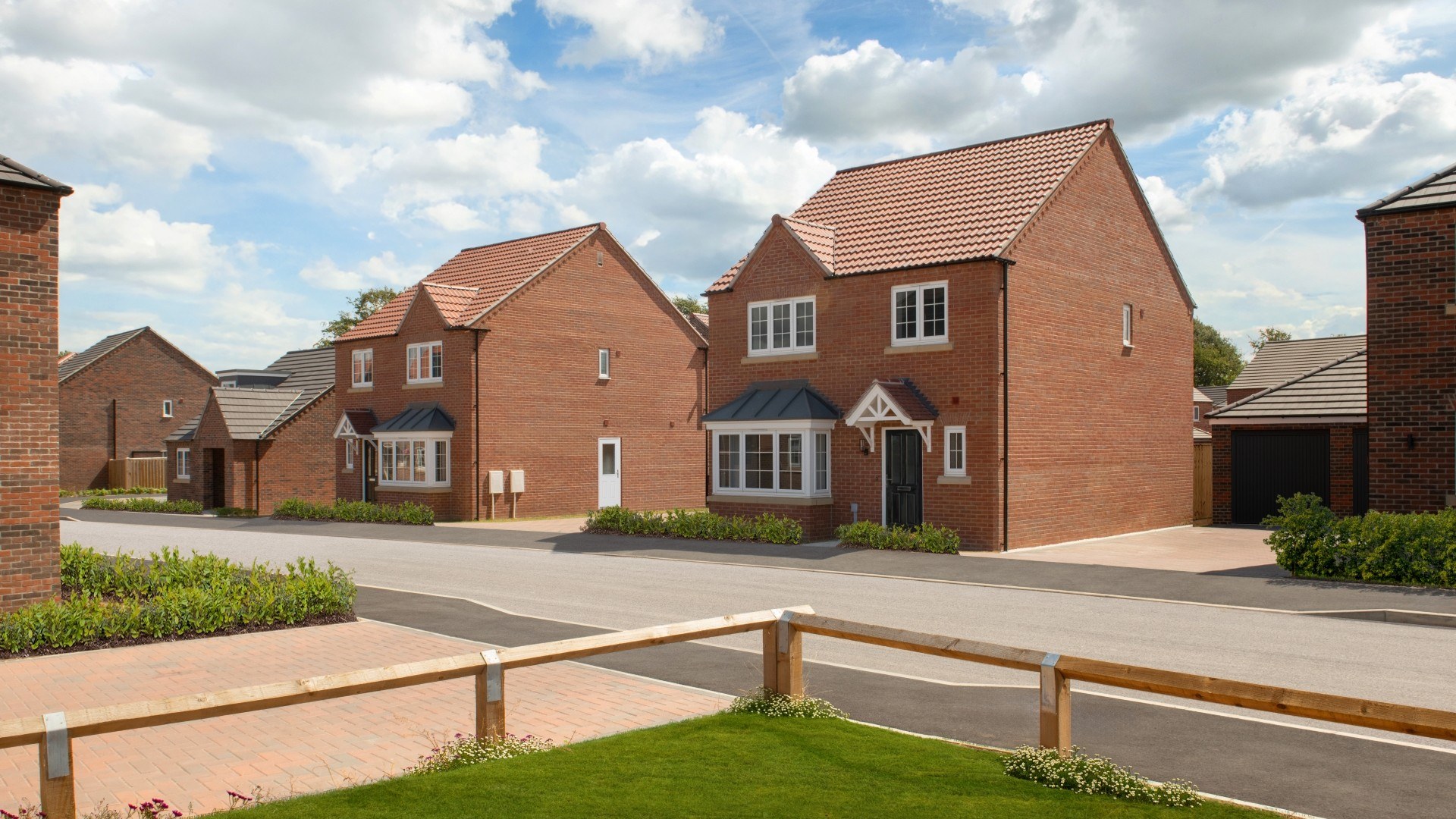 Street scene of detached homes including The Barden, a dormer bungalow 