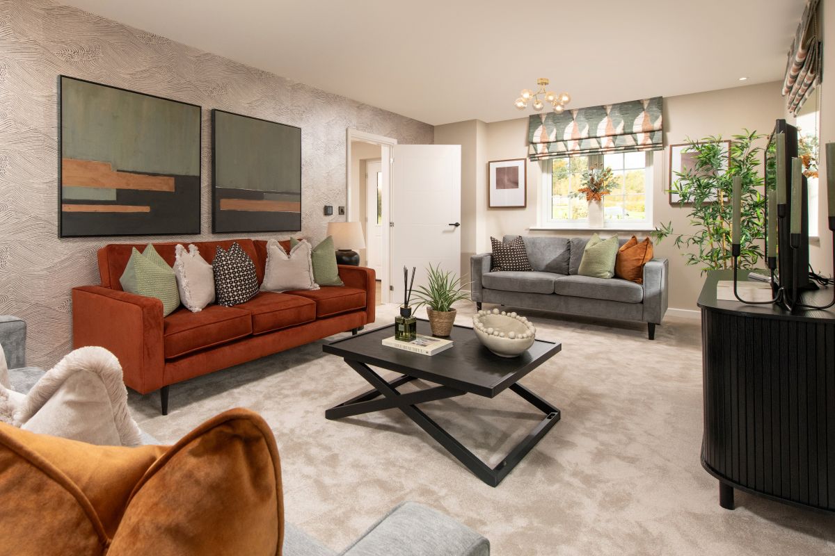 Spacious lounge with open door leading to the hallway.  One large sofa and two, two seater sofas framing either side of the room with a contemporary black coffee table in the centre of the room