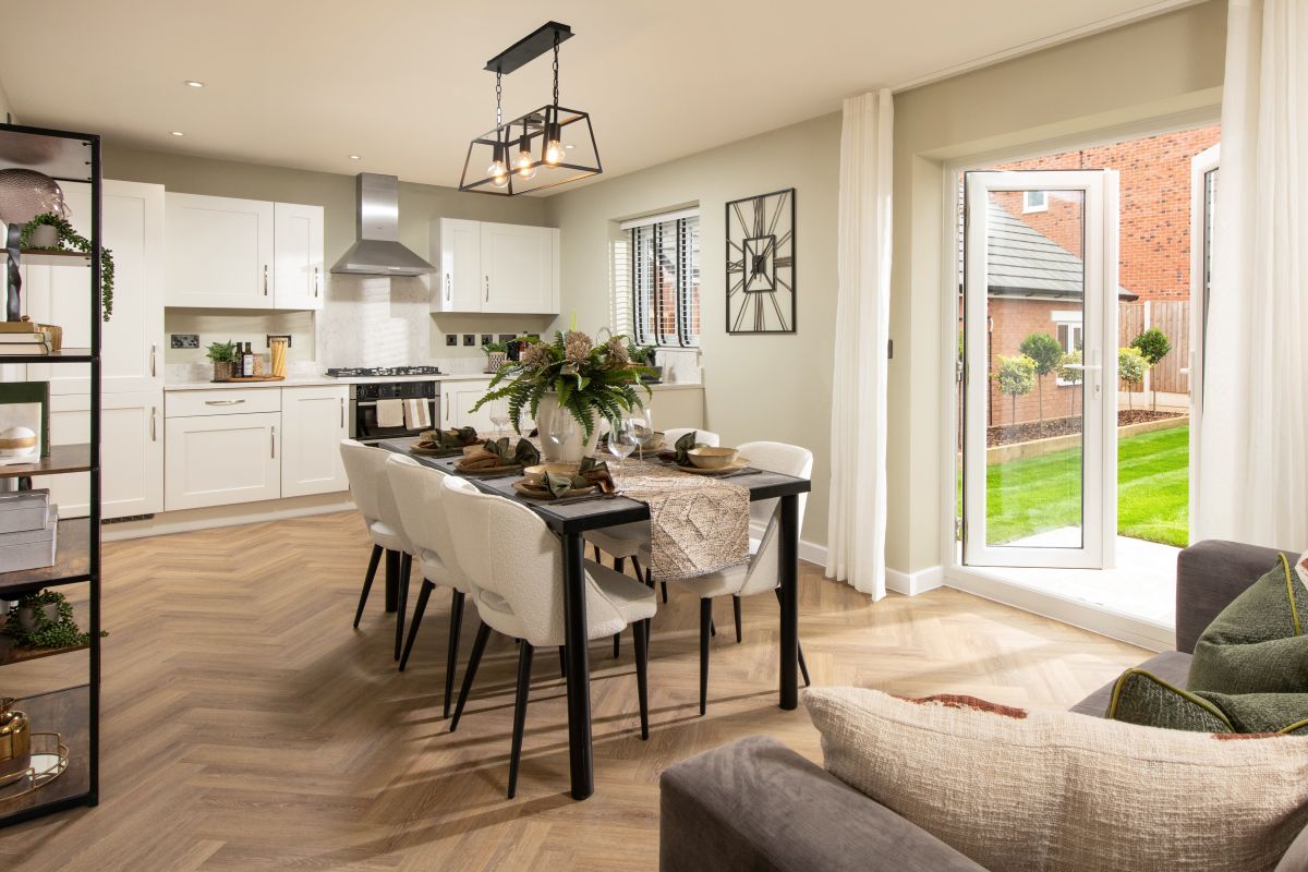 Light-filled open-plan kitchen, dining, family room with bi-fold doors opening to the garden