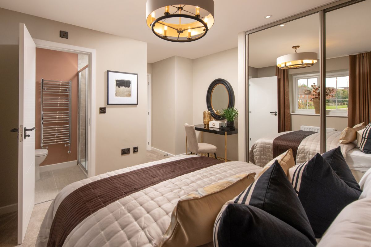Main bedroom with double bed, fitted wardrobe and door leading into ensuite