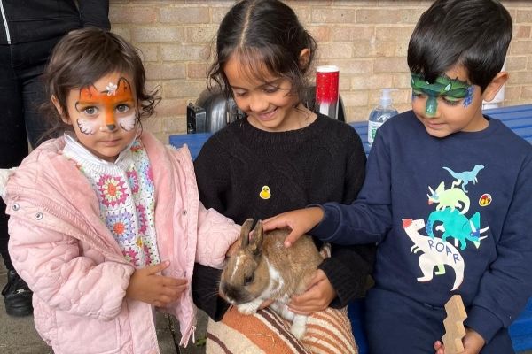 Pupils from Lower Harlington School enjoying the petting corner at the Summer Fayre