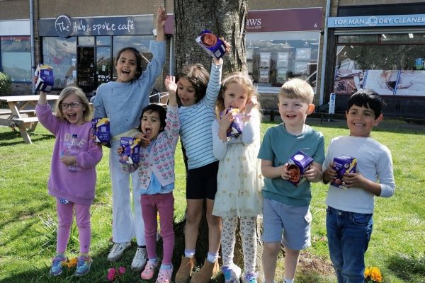 group of children holding up easter eggs