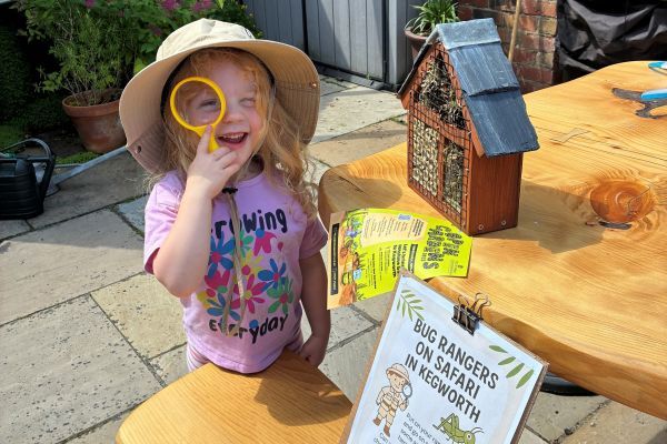 Young girl looking through magnifying glass