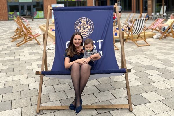 Lady with baby sitting in giant deckchair